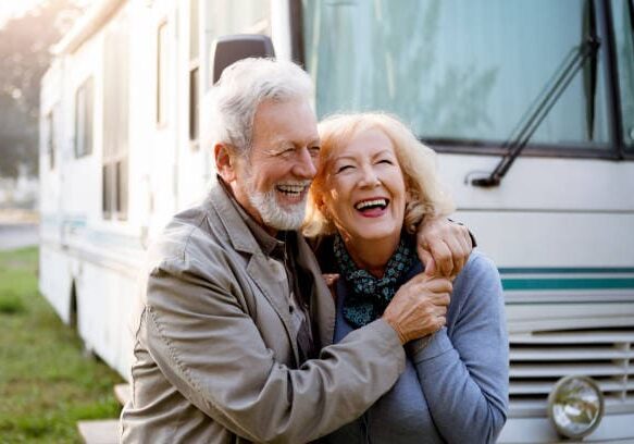 Seniors smiling in front of Luxury Motor Home ,recreational vehicle